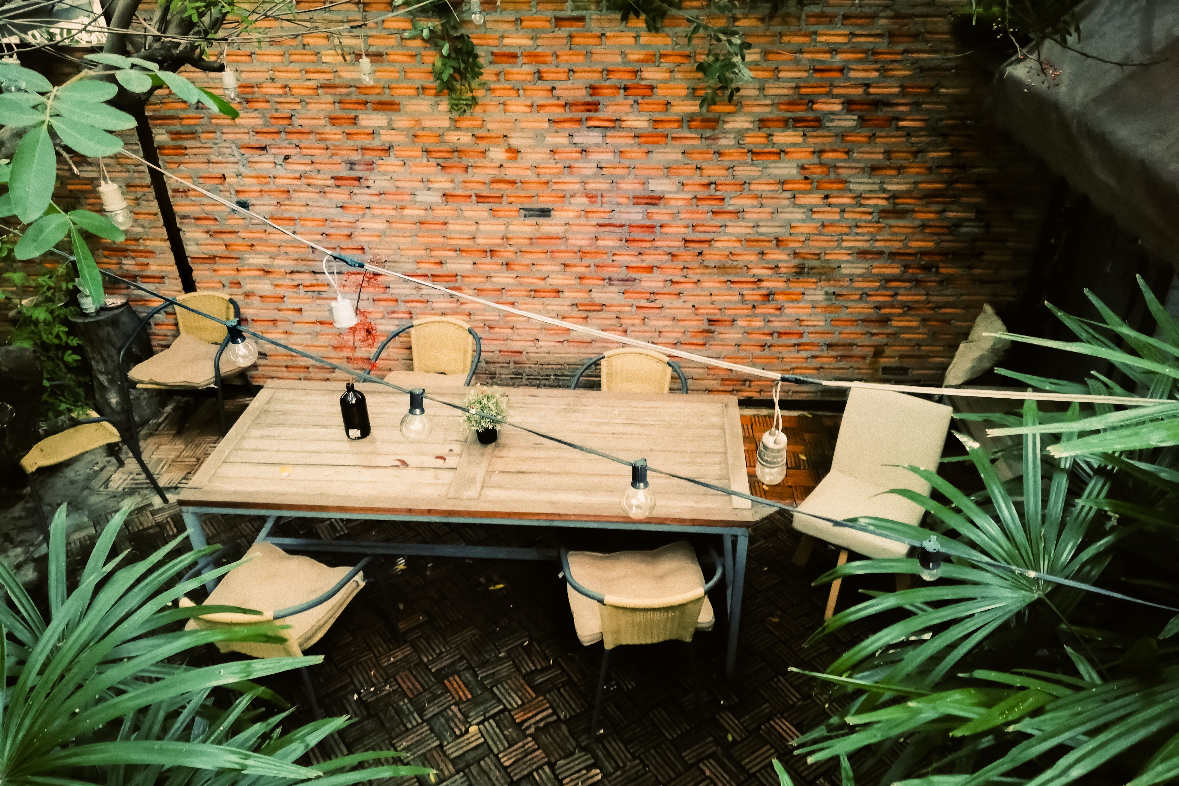 Outdoor table in courtyard with brick wall