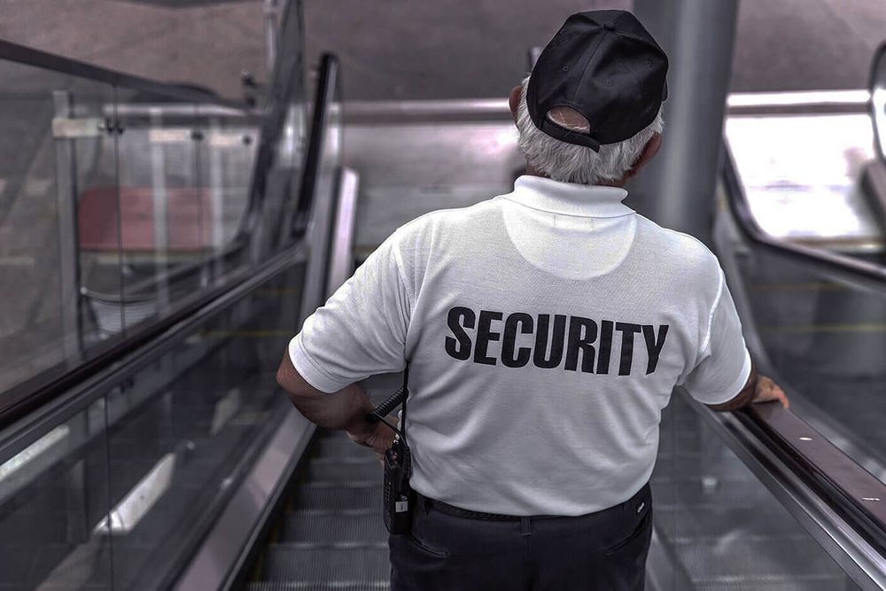 Security guard going down escalator