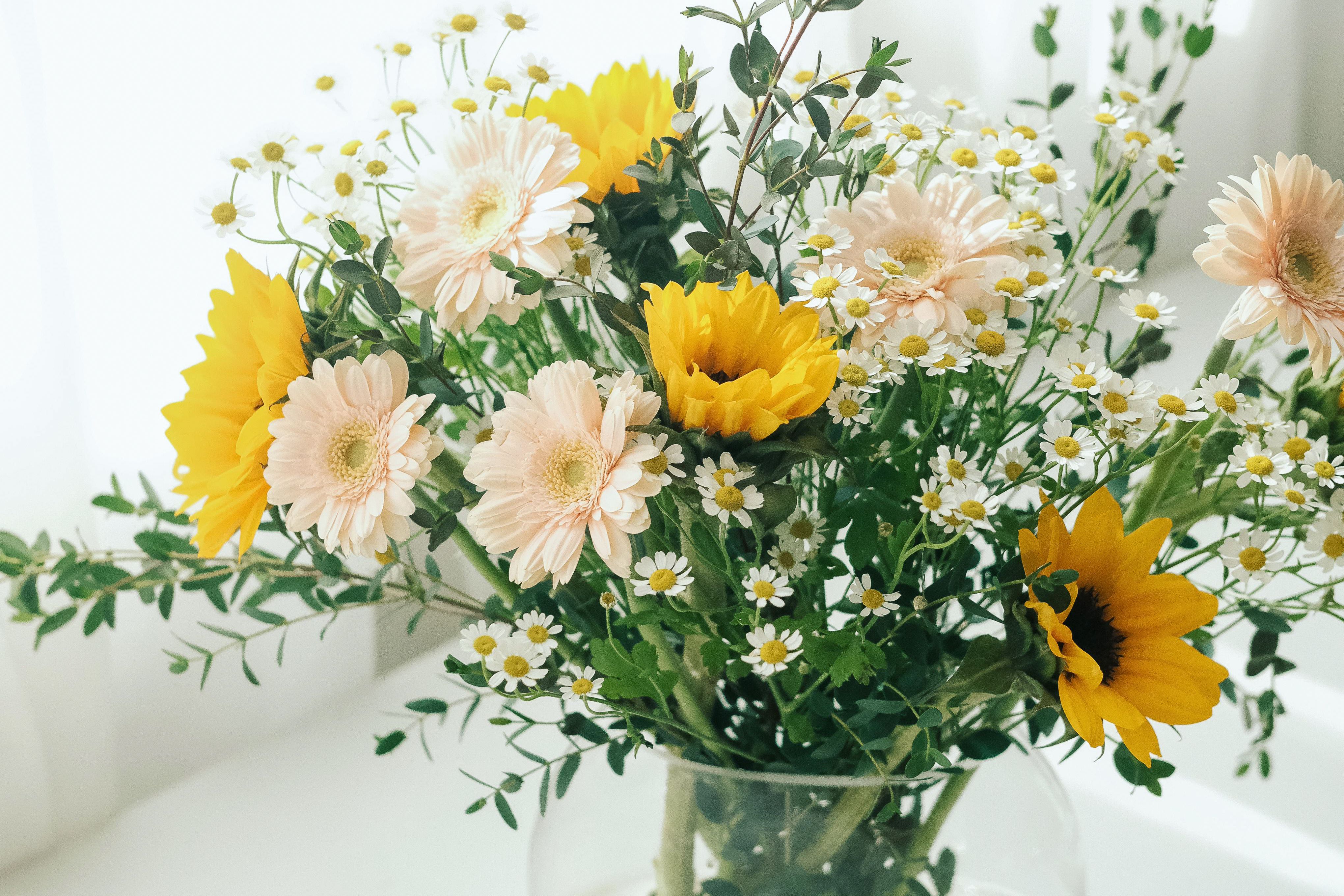 A bunch of flowers in a glass vase.
