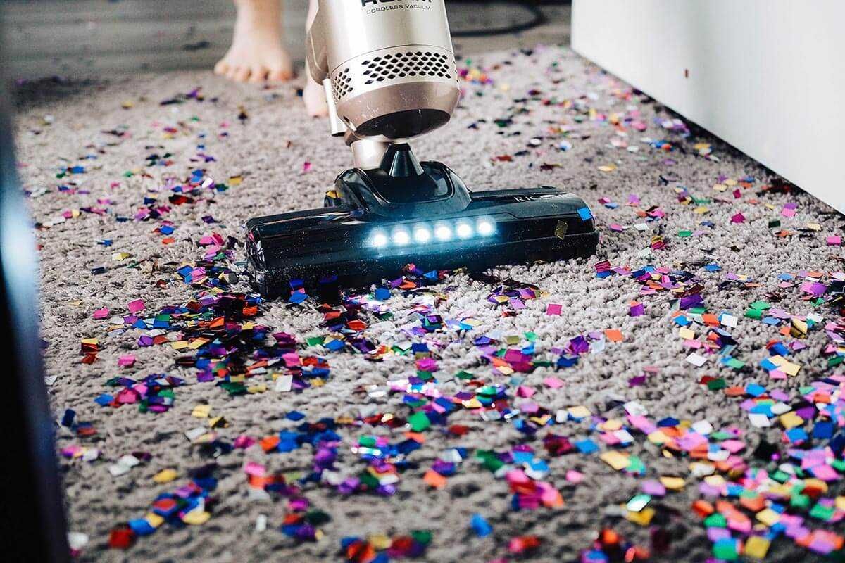 Vacuum cleaner cleaning up graffiti on rug