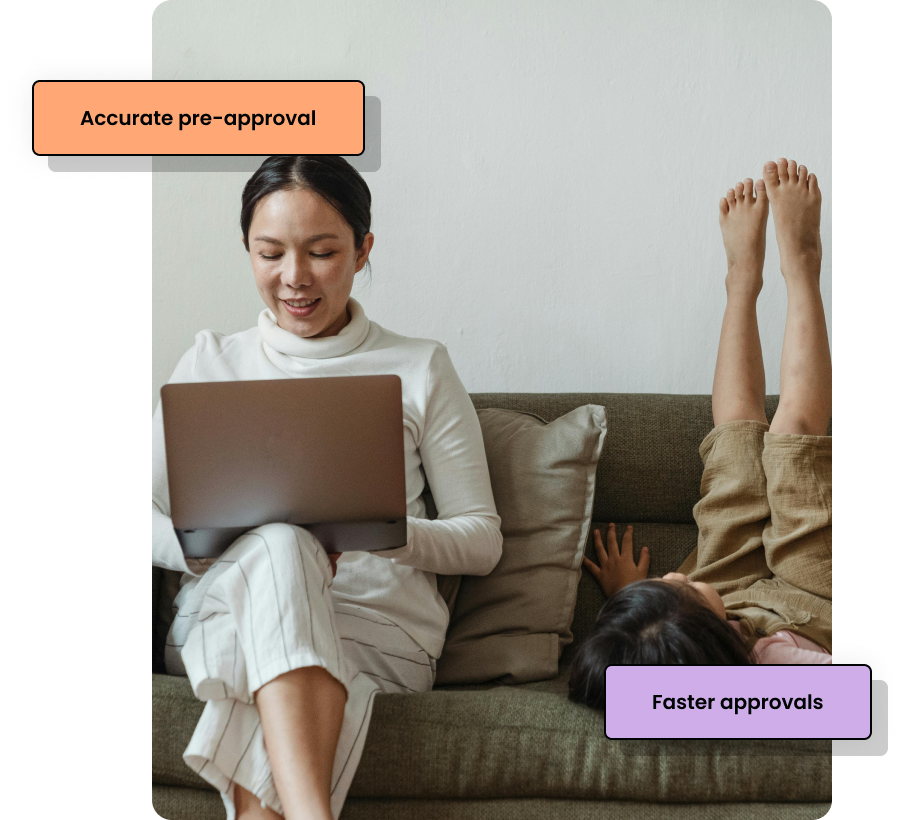 Woman on sofa with laptop and child playing next to her