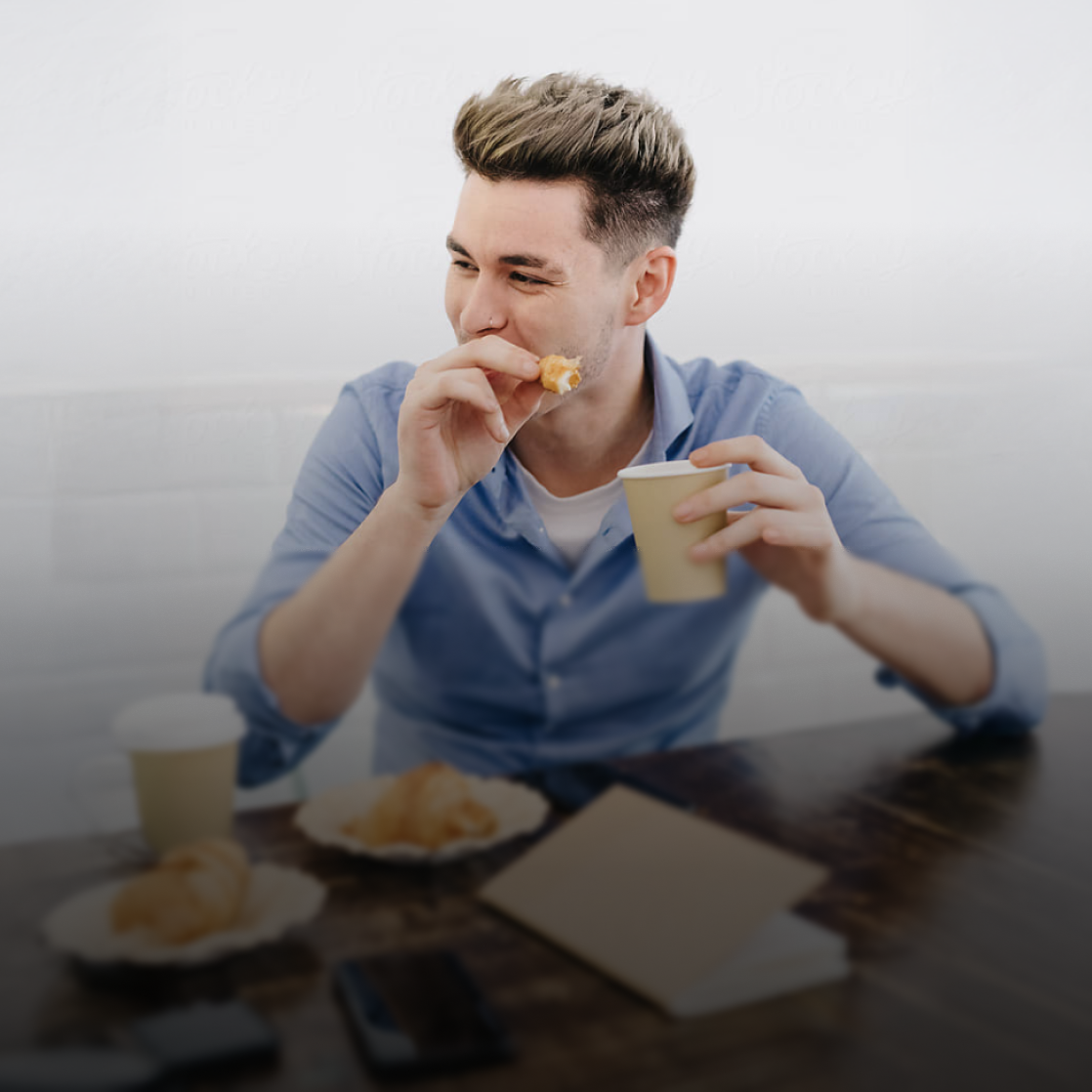 Young man eating breakfast 