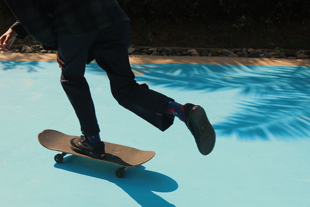 Person riding skateboard on blue road