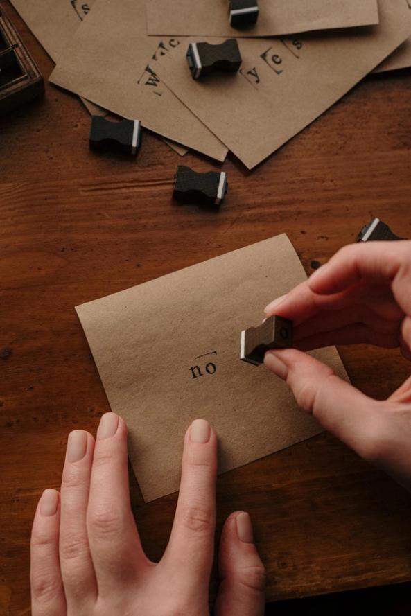 Stamp on a brown piece of paper with the word 'no'. 