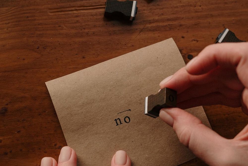 Stamp on a brown piece of paper with the word 'no'.
