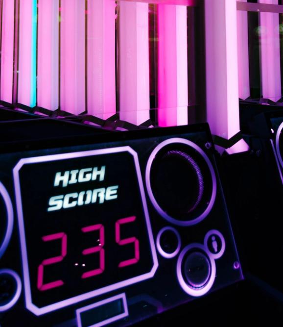 Neon lighting with a console reading high score and the number 235.
