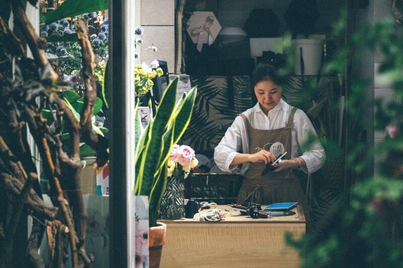 Florist in shop with apron