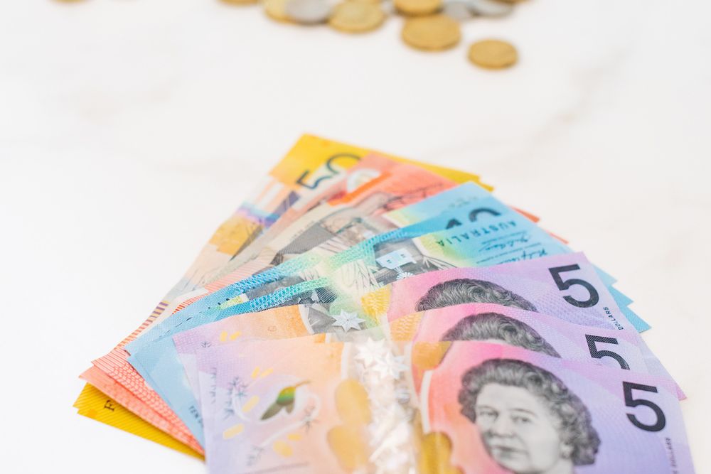 Australian dollars in notes and coins on table