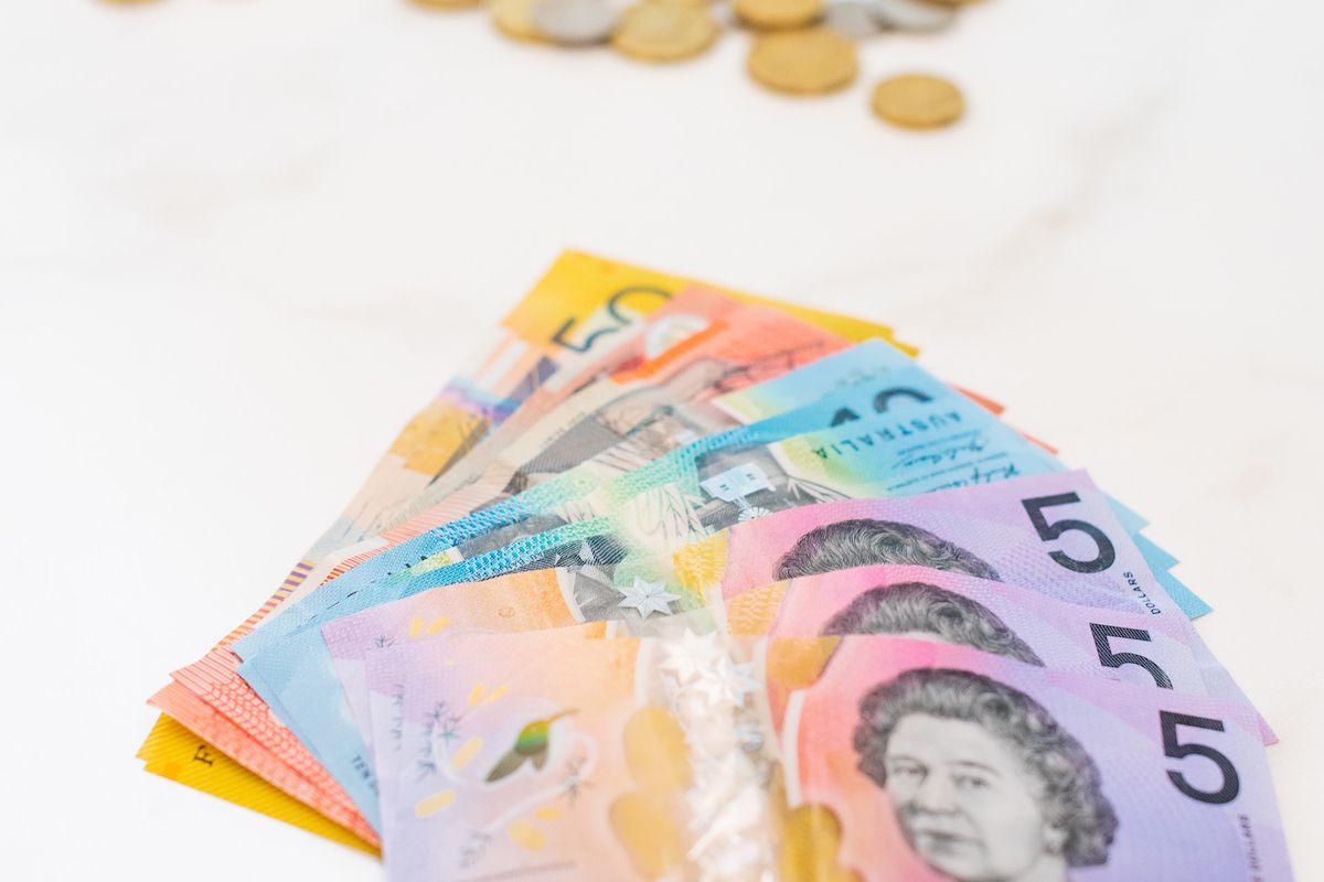 Australian dollars in notes and coins on table