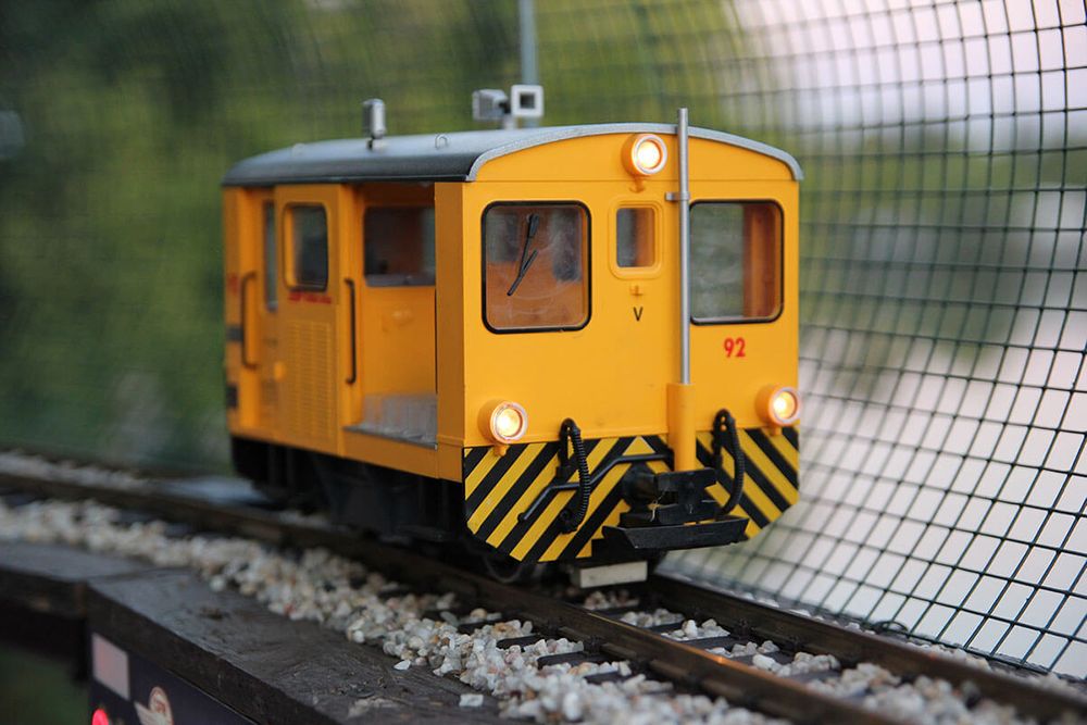 Model toy train on train tracks.