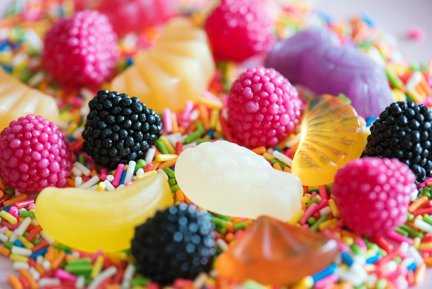 Large pieces of candy sit upon a bed of small candy.