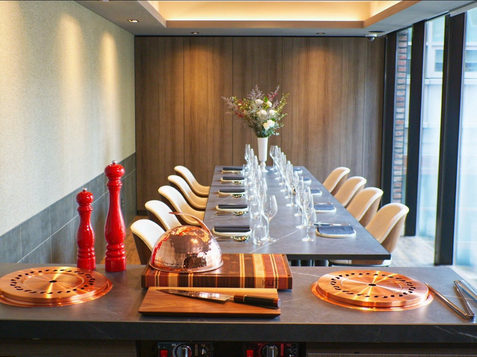 The 6–12 guest private room at KUT SEOUL in Jongno, long table set beside the window with the room's own grill station