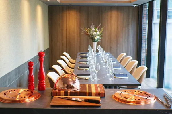 The 6–12 guest private room at KUT SEOUL in Jongno, long table set beside the window with the room's own grill station