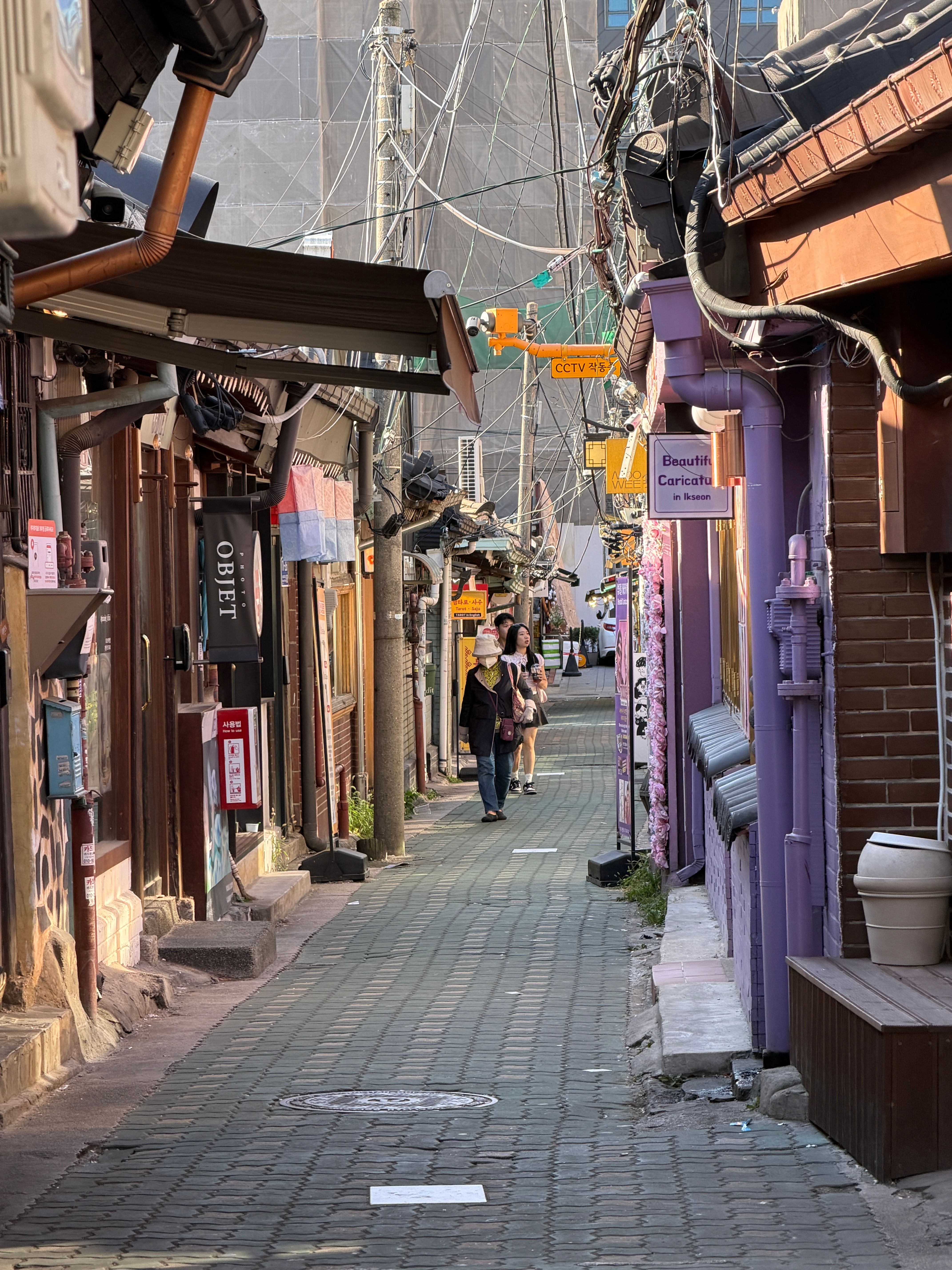 A narrow hanok alley in Ikseon-dong lined with small shops and cafes