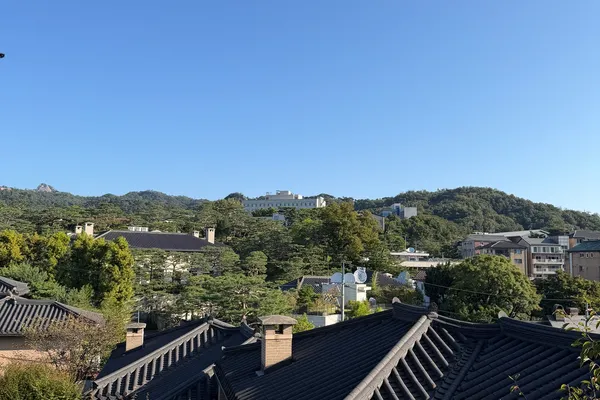 Tiled hanok rooftops in Bukchon Hanok Village with Bugaksan mountain behind