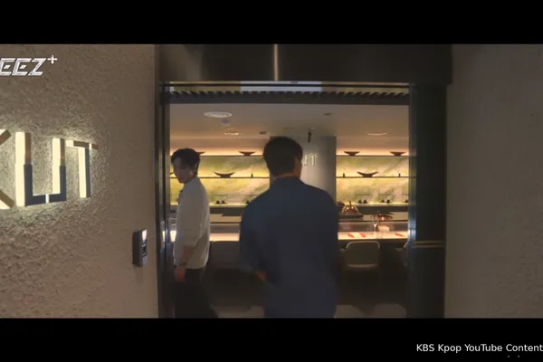 조명이 켜진 로고와 따뜻한 실내 빛이 흐르는 KUT SEOUL 한우 오마카세 레스토랑 입구로 들어서는 손님들