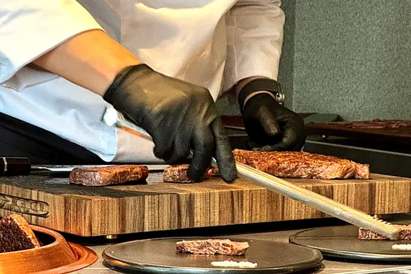 Chef Benjamin Kang slicing the day's cut of four-week wet-aged Hanwoo at the KUT SEOUL counter