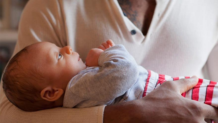 New dad holding newborn baby