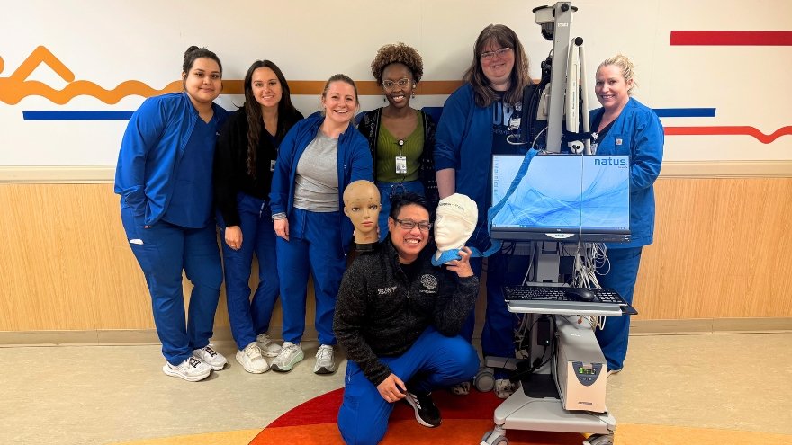 The Electrodiagnosis department at Renown Health poses for a group photo with their equipment.