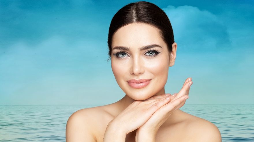 Beautiful woman smiling in front of ocean background