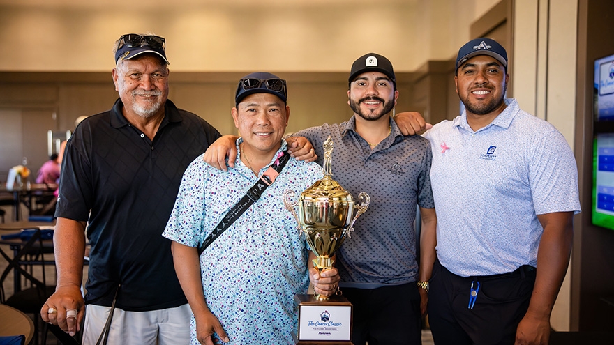 Winning participants of Cancer Classic 2025 posing with trophy.