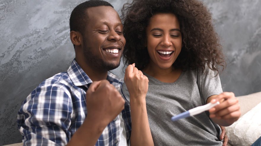 A couple looking at a pregnancy test