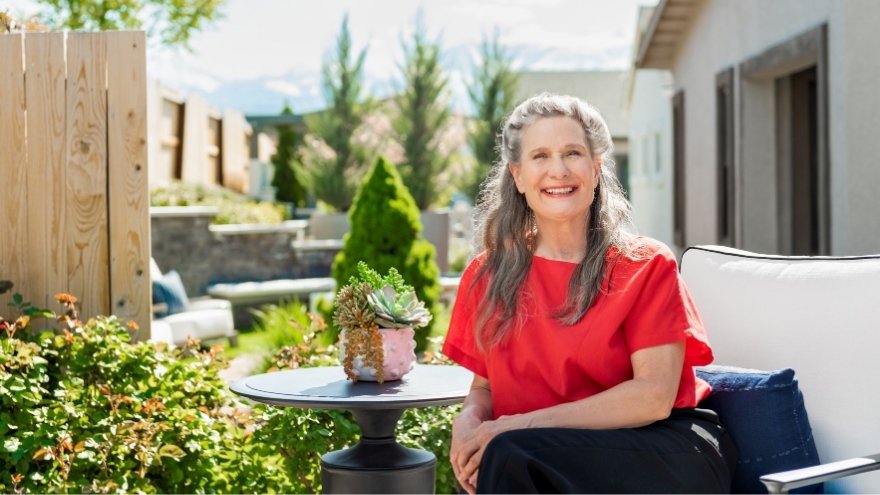 Senior Care Plus member Amy Hebel-Brenner smiles for a photo outside.