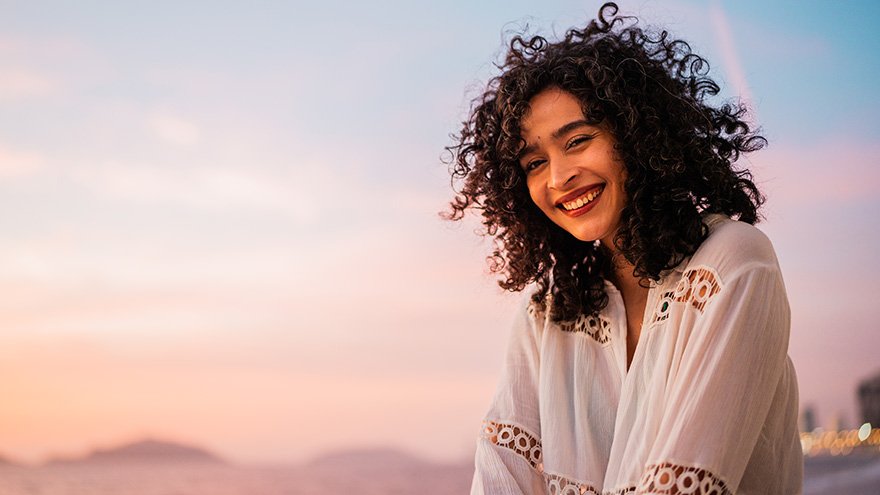 Woman smiling while at the beach