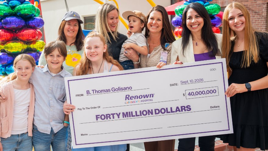 Families and children's hold up a $40 million check to Renown Children's Hospital from Tom Golisano.