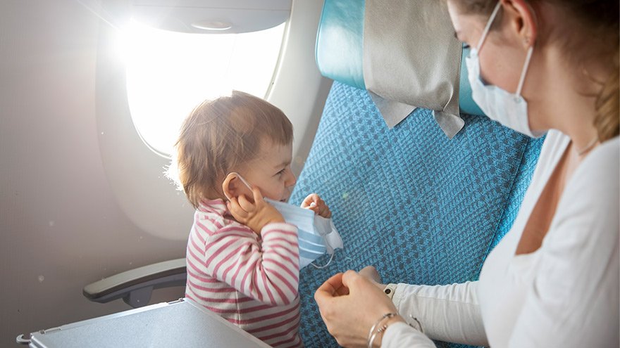 A woman and a child wearing face masks