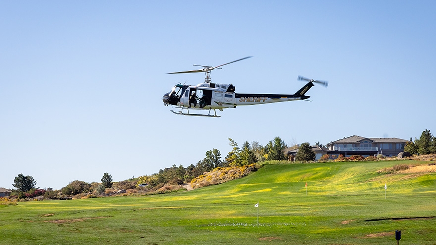 Helicopter hovering over ArrowCreek Golf course.