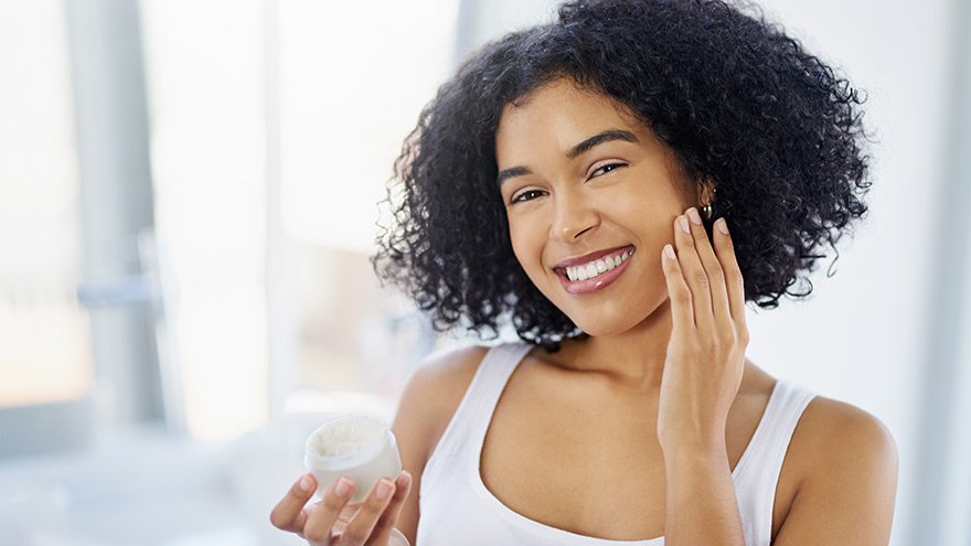 Young woman going through her morning skincare routine at home