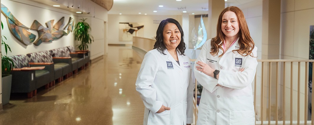 UNR Residents Dr. Barangan and Dr. Luntsford posing in hospital walkway