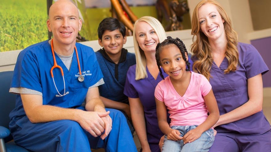 Doctor, nurses and children sitting 