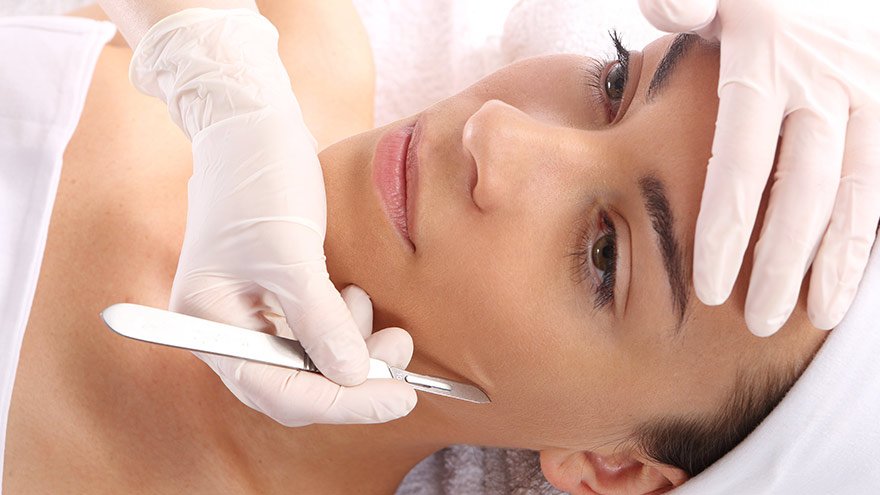 Woman having a dermaplane treatment
