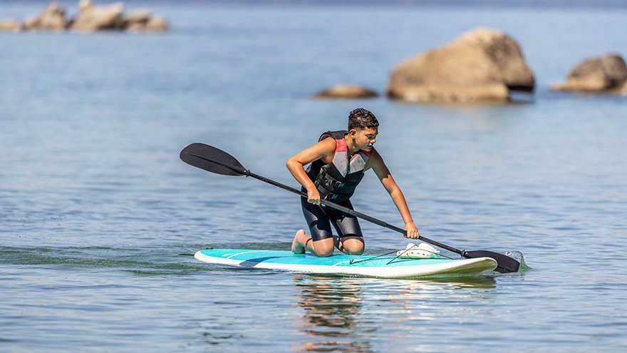 Teen boy paddleboarding at Lake Tahoe Nevada