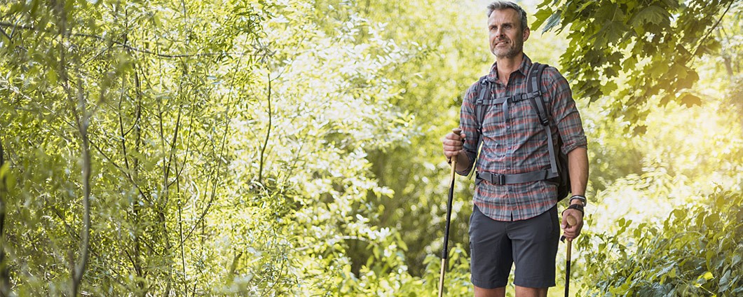 Man hiking surrounded by trees