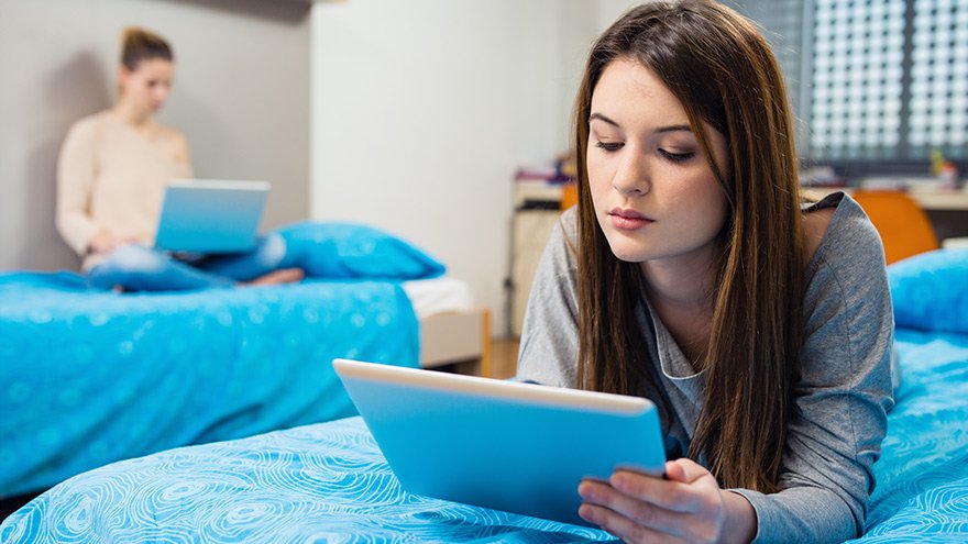 Two female college students learning in their dorm room