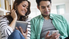 Young couple looking on mobile phones