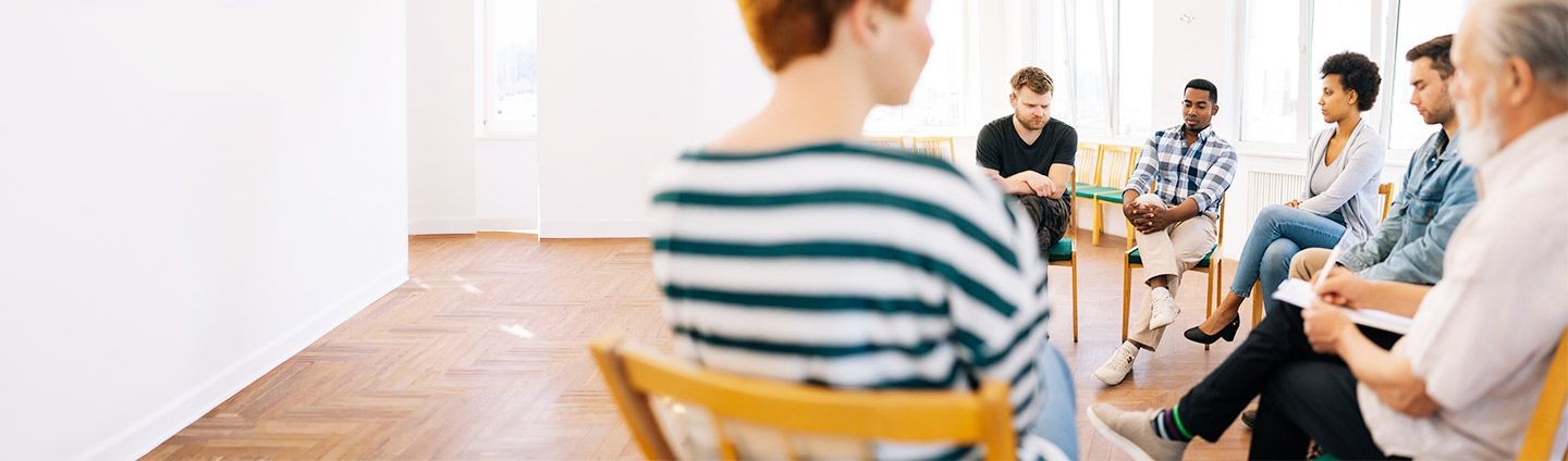 Adults participating in a group therapy session