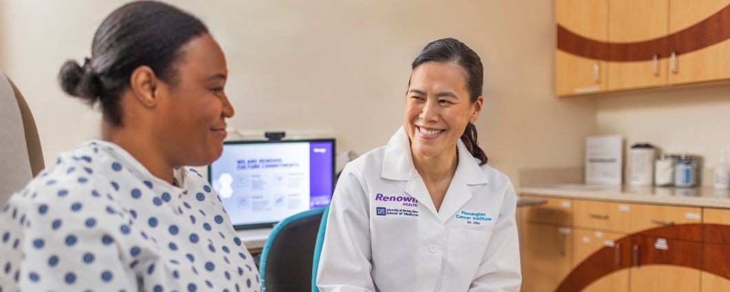 Breast surgical oncologist speaks with patient during consult