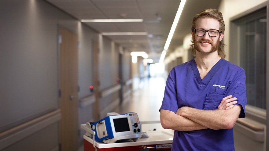 ICU Nurse, Ian Dwyer posing with equipment.