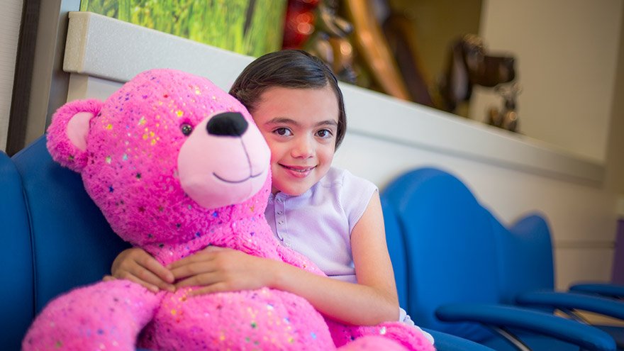 Young patient holds teddy bear at Renown Children's Hospital