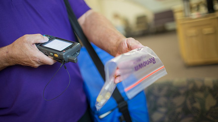 Renown employee scanning medication