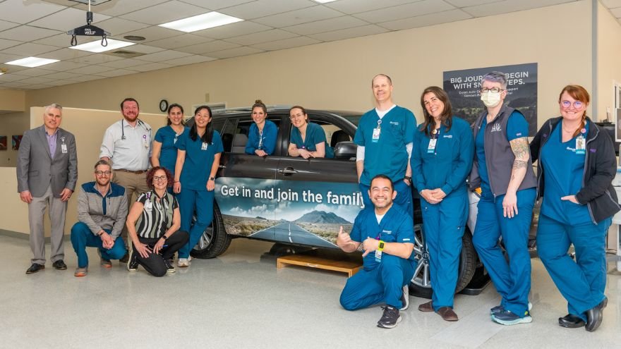 Several employees of Renown Rehab stand near donated vehicle from dolan toyota