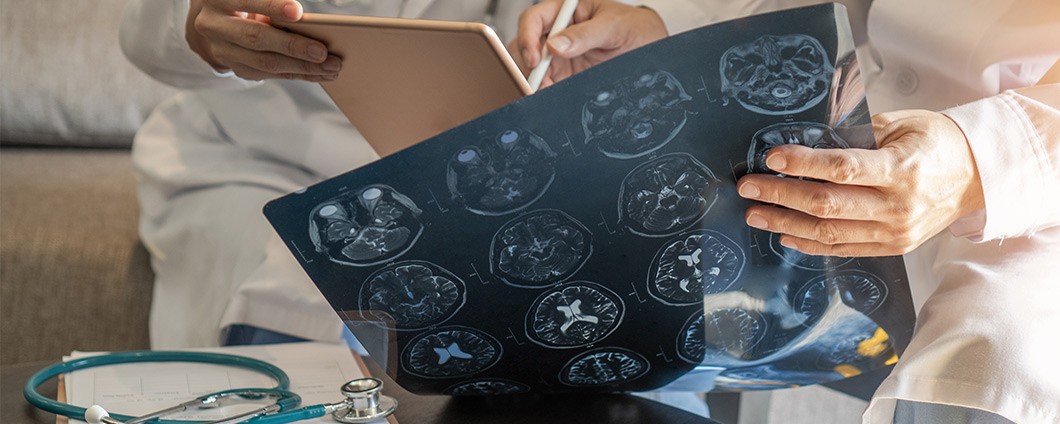 Surgeon with digital tablet diagnosing on patient care.