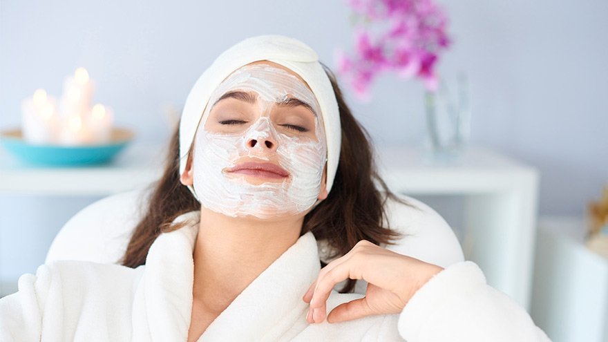 Woman enjoying a facial in a spa setting
