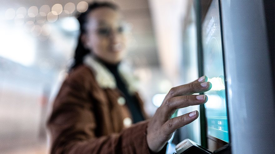 Close up of young woman checking in at a kiosk for her lab appointment