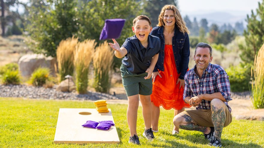Family playing cornhole