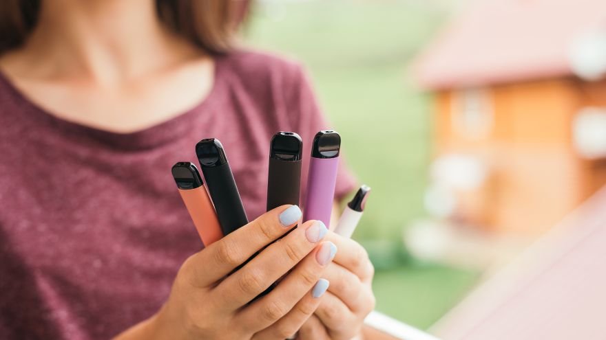 Teenager vaping outdoors